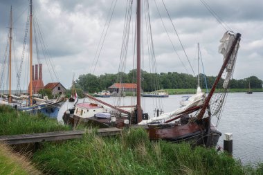 Traditional fishing village with small houses, a church and ships in Enkhuizen, North Holland in the Netherlands.