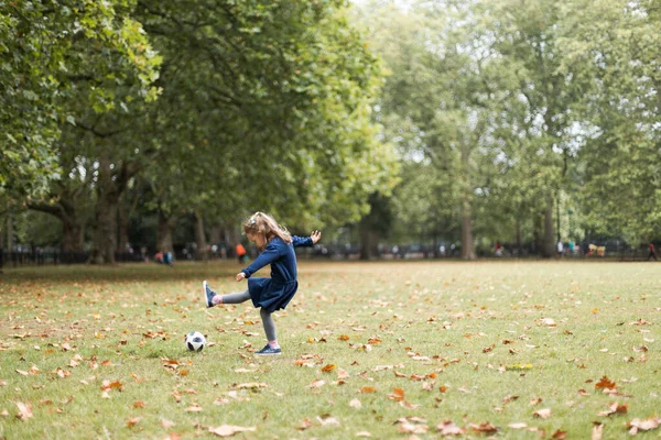 Little girl playing outside in the park