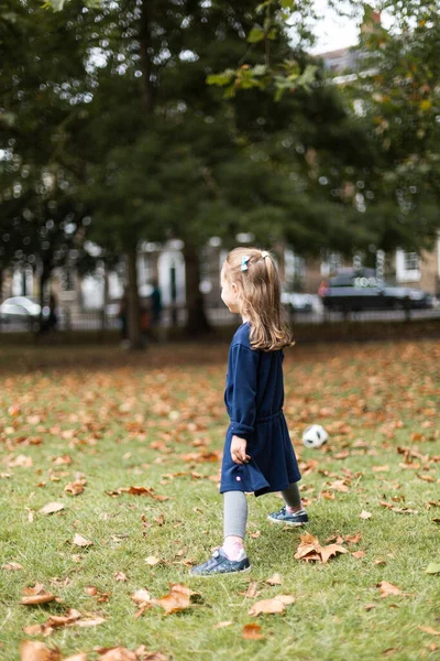 Little girl playing outside in the park