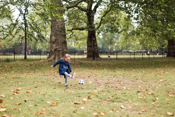 Little girl playing outside in the park