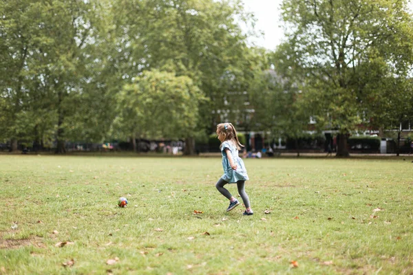 Little girl playing outside in the park