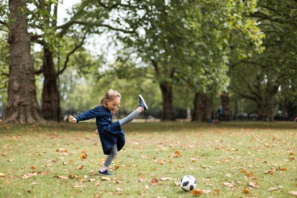 Little girl playing outside in the park with her father