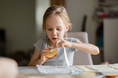 Little girl helping with baking at home