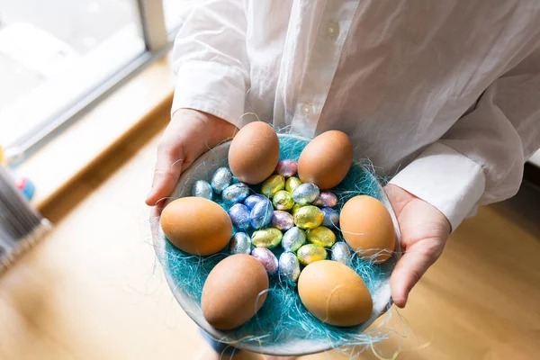 easter eggs in the hands of a woman.