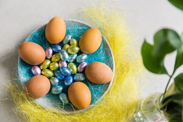 easter eggs in a nest on the plate