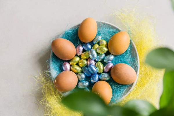 easter eggs in a nest on the plate