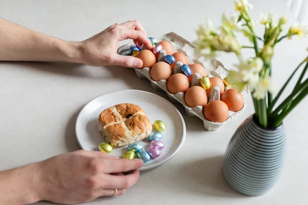 man holding easter eggs in hands on table