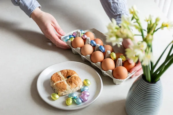 man holding easter eggs in hands on table