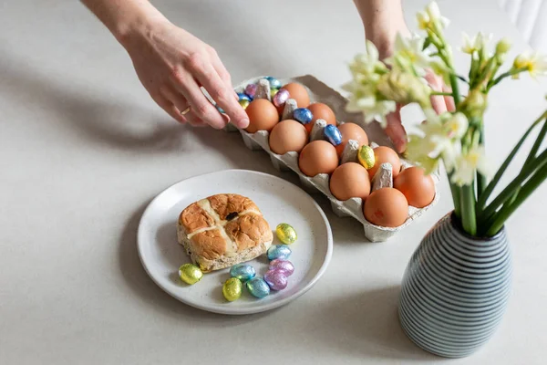 man holding easter eggs in hands on table