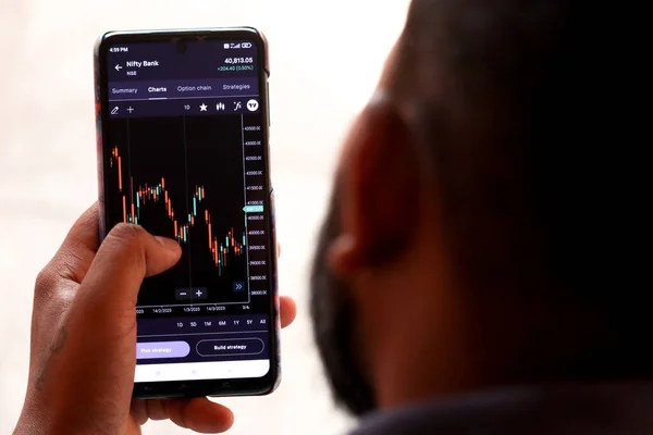 stock image young boy doing stock market inspection in the phone closeup picture