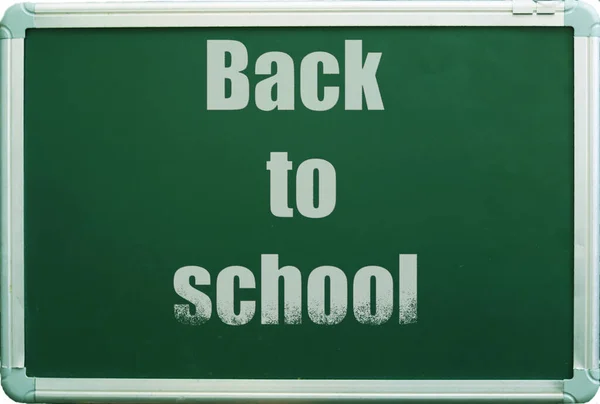 back to school written on a green board with white letters