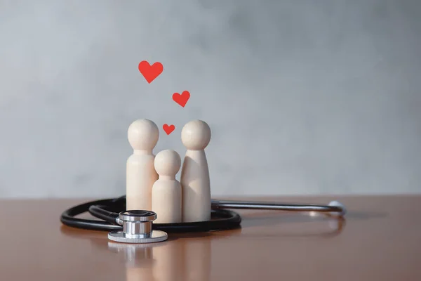 Family with stethoscope and red heart The concept of physical examination and family health insurance.