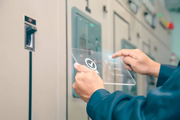 stock image Engineer inspecting high voltage control equipment, maintenance concept