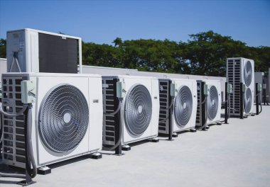Air conditioning (HVAC) installed on the roof of industrial buildings. clipart