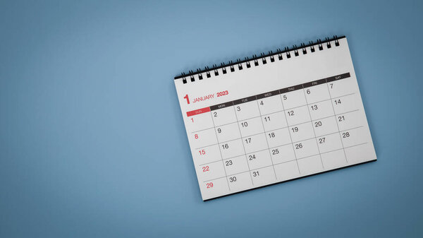 White calendar laying on blue background planning concept.