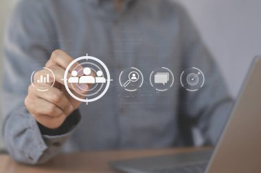 İş pazarlama konsepti, iş adamı müşteri hedef grubu için oklu dart tahtası simgesi tutuyor.