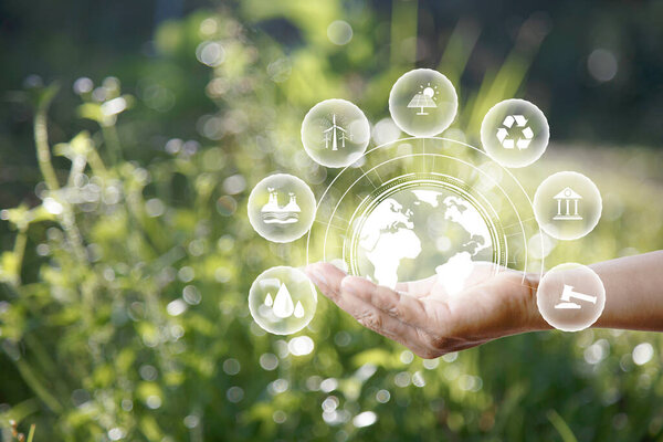 green energy concept. Global warming icons set on hands with nature green background. Net zero 2050 green energy icon around Carbon Neutral in industry. Net zero emissions concept. innovation idea