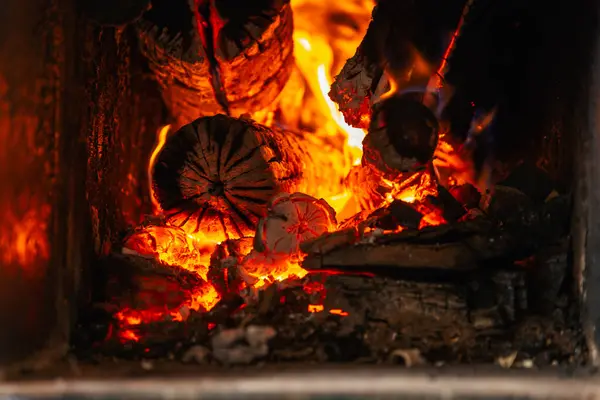 Katı bir yakıt kazanında yanan odunların yakın plan görüntüleri.