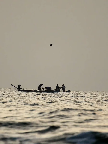 Stock image silhouette of boat in the sea, early morning fishing in the sea