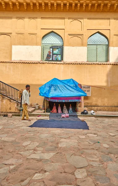 stock image Jaipur, India ; 07-02-2023 : a roadside stall of indian cultural things with shopkeeper in Amber fort