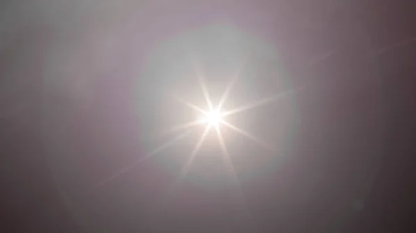 Abstract Natural Sun flare on the black sky background, lens flare