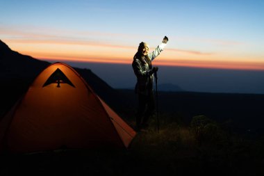 Kamp alanı macerasında büyüleyici günbatımı özçekimi. Açık hava fotoğrafçılığı. Canlı manzara.