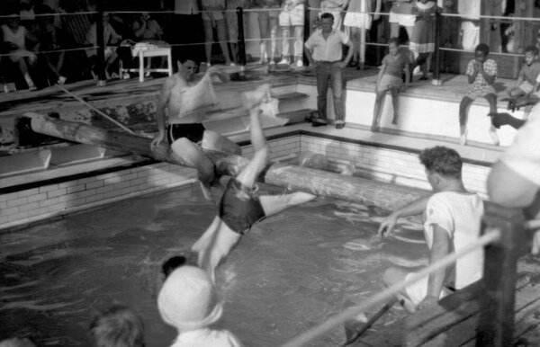 Two people battling on a greasy pole on board the MV Aureol en route from Liverpool to Tema in Ghana c.1958