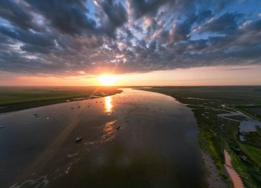 An aerial view of a spectacular sunset over the River Deben at Bawdsey Beach in Suffolk, UK clipart