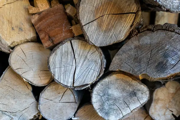 stock image A close up of firewood piled up in a log store in a garden in Suffolk, UK