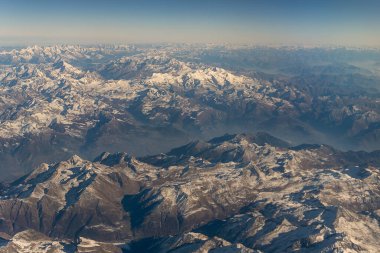 Flying over the French Alps on a clear Autumn morning clipart