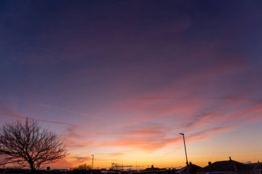 The colourful sunset above the rooftops of Barrow in Cumbria, UK clipart