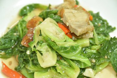 Kızarmış Brüksel lahanası ve dilimlenmiş istiridye soslu domuz eti. 