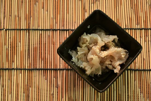 fermenting jellyfish in white sesame oil on bowl