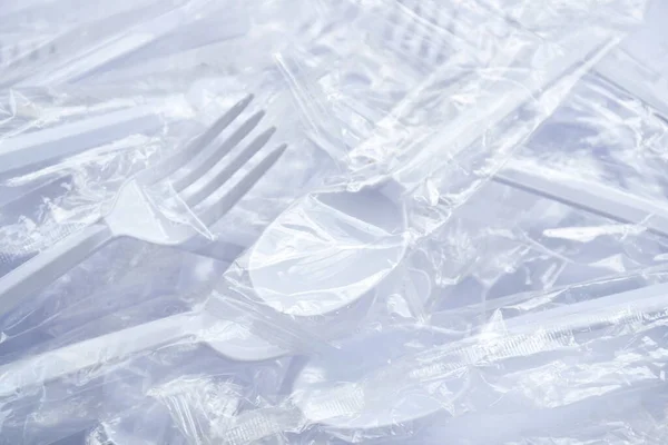 plastic spoon and fork for single used in transparent packaging  arranging on white background