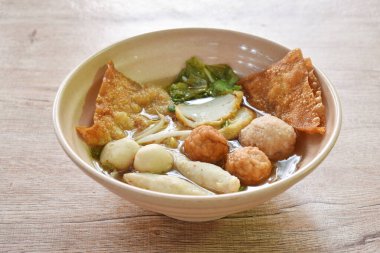 boiled Hakka meatball made fish and shrimp with bean sprout and lettuce in spicy soup on bowl