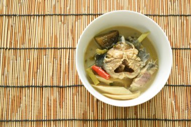 spicy boiled catfish with bamboo shoot and yard long bean couple eggplant in fermenting fish sauce soup on bowl