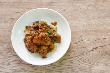 fried slice bass fish with onion in black pepper sauce on plate