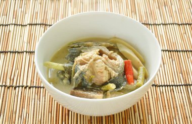 spicy boiled catfish with bamboo shoot and yard long bean couple eggplant in fermenting fish sauce soup on bowl