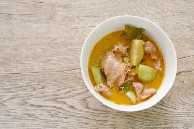 spicy boiled slice chicken and eggplant in coconut milk red curry soup on bowl