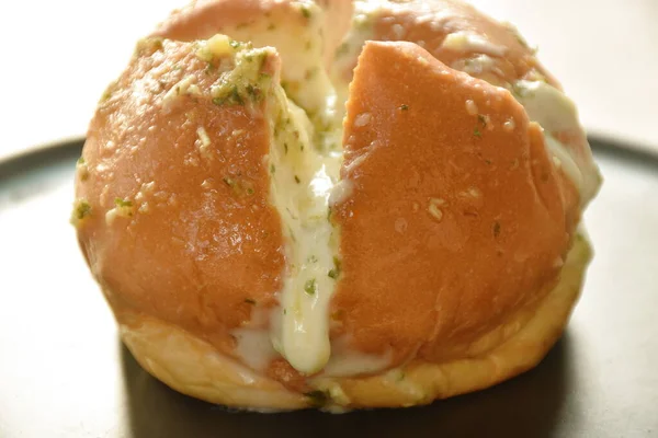 bread bun stuffed garlic cheese sauce arranging on plate