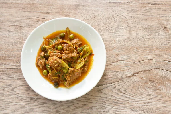 spicy fried barking deer meat with curry and eggplant on plate