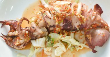 grilled squid dressing spicy and sour lemon sauce on plate