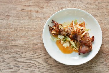 grilled squid dressing spicy and sour lemon sauce on plate