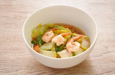 fried slice Chinese green cabbage and carrot with shrimp in soy sauce on bowl 
