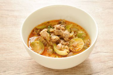 spicy boiled beef meat with eggplant in coconut milk green curry soup on bowl 