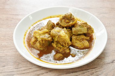 spicy boiled pork bone with curry and basil leaf on plate