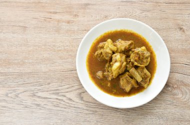 spicy boiled pork bone with curry and basil leaf on plate