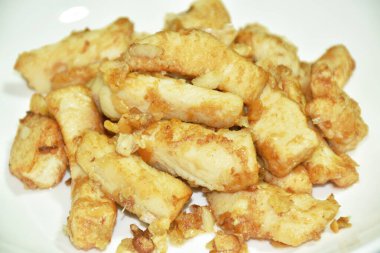 fried slice chicken meat with salt and garlic on plate