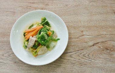 Kızarmış yeşil Çin lahanası ve tabakta domuz eti ile havuç karıştır.   