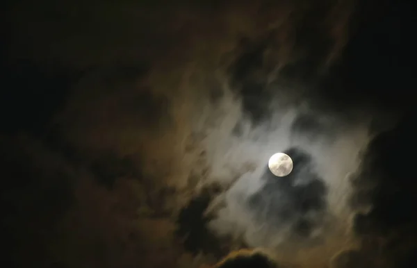 bright moon floating on sky in cloud background